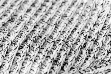 White and black knitted woolen texture background close up