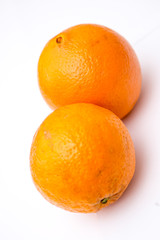 Two whole oranges on the white background