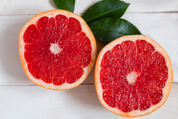 a large grapefruit cut in half on a table top