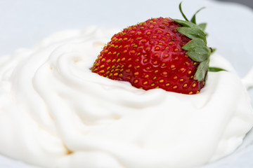 The white cream and strawberry mixing in it