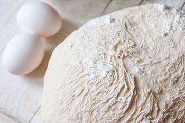 Fototapeta na wymiar kneaded prepared dough on the table