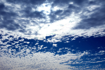 Naklejka na ściany i meble Blue sky background with a tiny clouds. Sunny day