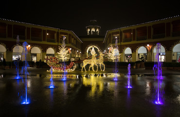 MILAN, ITALY, DECEMBER 21, 2018 - Shopping center "Serravalle Outlet" on Christmas days by night, near Milan, Italy