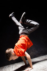 Young russian bboy doing some stunts on the stage