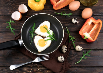 fried eggs in the form of a heart in a skillet