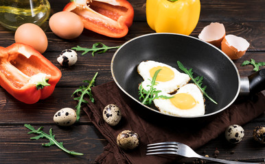 fried eggs in the shape of a heart in a pan