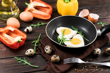 fried eggs in the shape of a heart in a pan