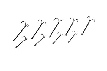 double hooks for fishing of various sizes on a white background close-up