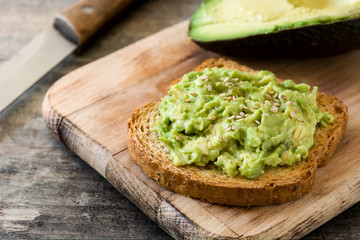 avocado toast with sesame seeds on wooden table
