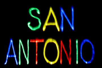 Light painting. City name. SAN ANTONIO, Blue, yellow, green and red.