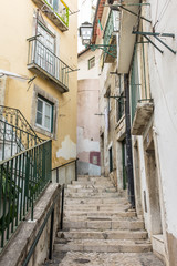 Fototapeta na wymiar Narrow alleyway and steps in Alfama, Lisbon, Portugal