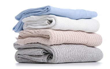 Stack folded sweaters on white background isolation