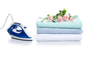 Stack towels with iron flowers on white backgroundd isolation