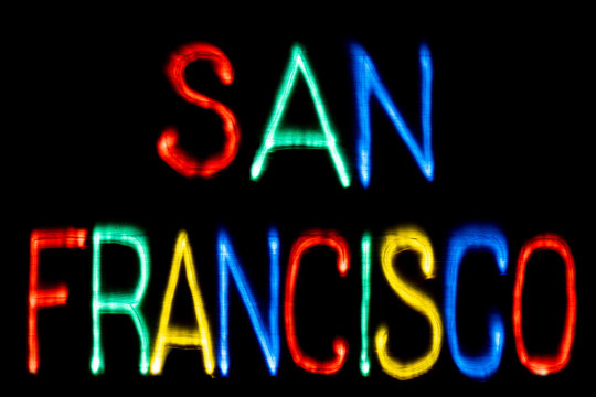 Light painting. City name. SAN FRANCISCO. Blue, yellow, green and red colors. Black background.
