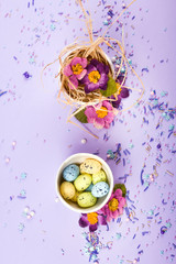 Easter decor in pastel colors. Easter eggs, candy, sweets, flowers and eggshells.