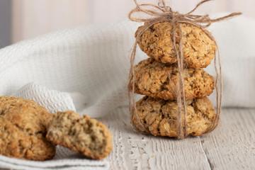 Oatmeal cookies with milk on tray on rustic wooden table