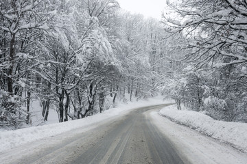 Heavy snow on a slippery winter road