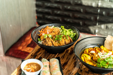 Delicious Thai inspired noodle bowl with chicken, carrots, scallions, and lettuce. Food from Thailand.