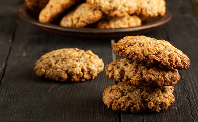 Oatmeal cookies with milk on tray on rustic wooden table