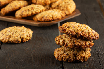 Oatmeal cookies with milk on tray on rustic wooden table