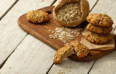 Oatmeal cookies with milk on tray on rustic wooden table