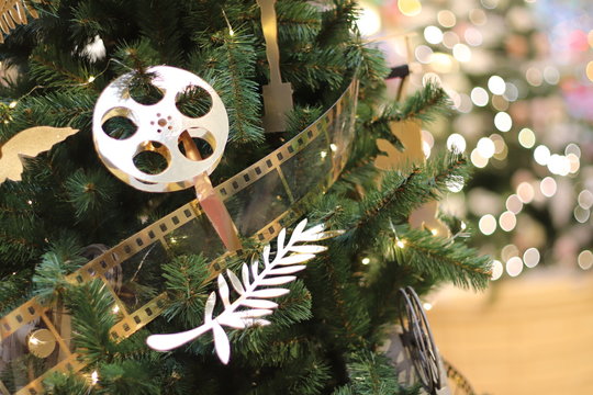 Cinema film tape and Christmas tree. Movie decorations on the tree. Going to the cinema on New Year's holidays