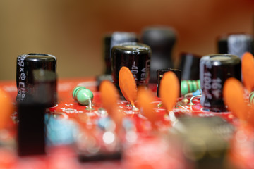 Close up (Macro) of Printed Circuit Board PCB embedded components (inductors, resistors, capacitors, diodes, microchips, transistor) with short depth of view