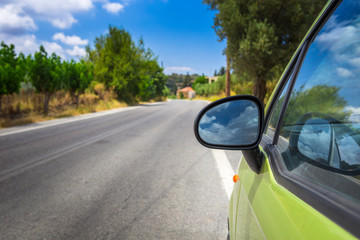 Side mirror of a green car