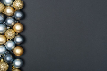 Multiple Christmas silver and gold baubles creative pattern with the black background and copy space