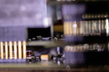 Close up (Macro) of Printed Circuit Board PCB embedded components (inductors, resistors, capacitors, diodes, microchips, transistor) with short depth of view.