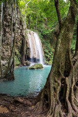 Fototapeta na wymiar Tropical waterfall with increadibly blue water. Erawan, Thailand