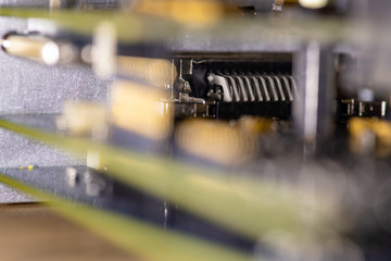Close up (Macro) of Printed Circuit Board PCB embedded components (inductors, resistors, capacitors, diodes, microchips, transistor) with short depth of view.