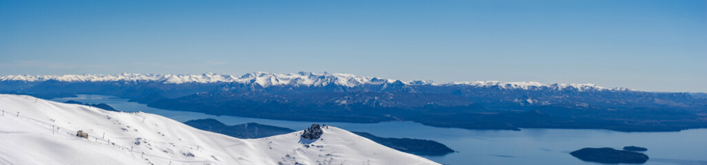 Panorama view Snowy peaks on a sunny day, with lakes and snowy mountains on the horizon. View of Catedral hill, Bariloche, Argentina.