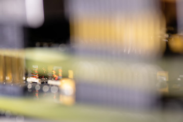 Close up (Macro) of Printed Circuit Board PCB embedded components (inductors, resistors, capacitors, diodes, microchips, transistor) with short depth of view.
