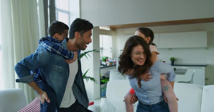 Portrait of happy family having fun  in slow motion on kitchen . Shot with RED camera in 8K. Concept of happy family, childhood, parenthood