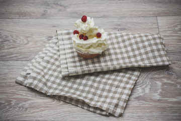 Fototapeta na wymiar Close-up shot with whipped cream, fresh berries on a light checkered linen napkin.
