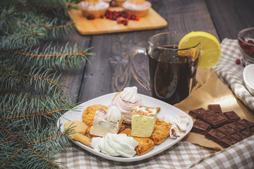 Happy New Year fir branches decorated with gingerbread stars, cinnamon sticks, dried orange slices...