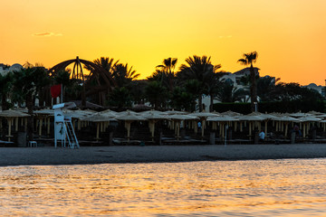 Sunset over the red sea palm tree silhuettes hotel in Makadi Bay Egypt