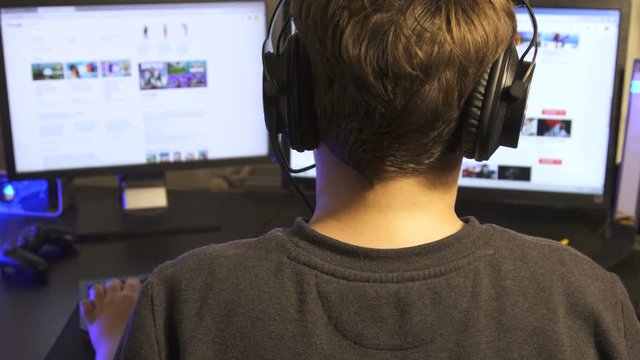 Close-up on the guru child  of the Gamer searching looking for in the Video Game oninternet
