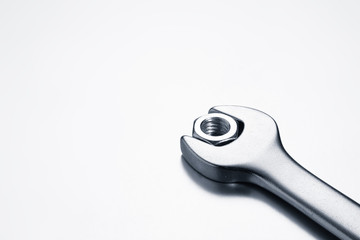 Wrench with set metal nut on white background	