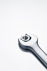 Wrench with set metal nut on white background	