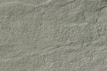 The texture of a gray stone surface. Grunge background with space for text or image. Gray backdrop.
