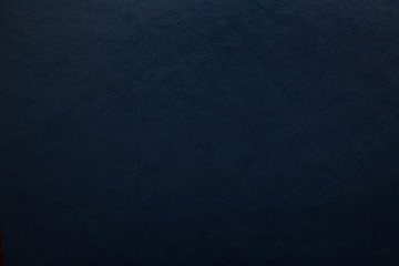 Dark blue textured leather background. Abstract leather texture.