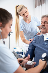 zwei Krankenschwestern pflegen einen intensiv wachkoma Patienten im Krankenhaus oder Pflegeheim auf 
