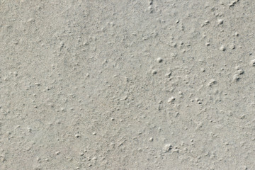 Gray backdrop. The texture of a light gray stone with a rough and matte surface. Grunge background with space for text or image. 