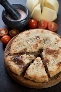 Close-up of sliced ossetian pie with meat stuffing, vertical shot