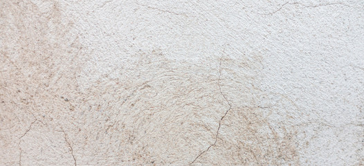 Old grungy wall with damaged plaster background texture.