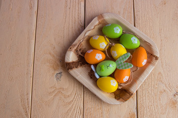 Easter, hare on a wooden plate on a wooden