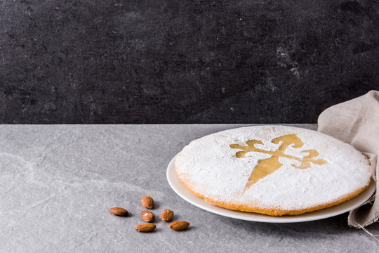 Tarta de Santiago. Traditional almond cake from Santiago in Spain on gray background