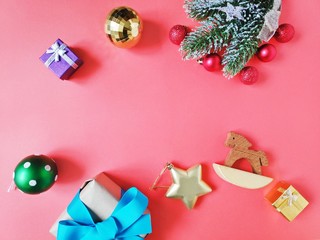 Christmas and New Year wallpaper. Wrapped gift, spruce branch, red, green, golden balls and wooden toy horse